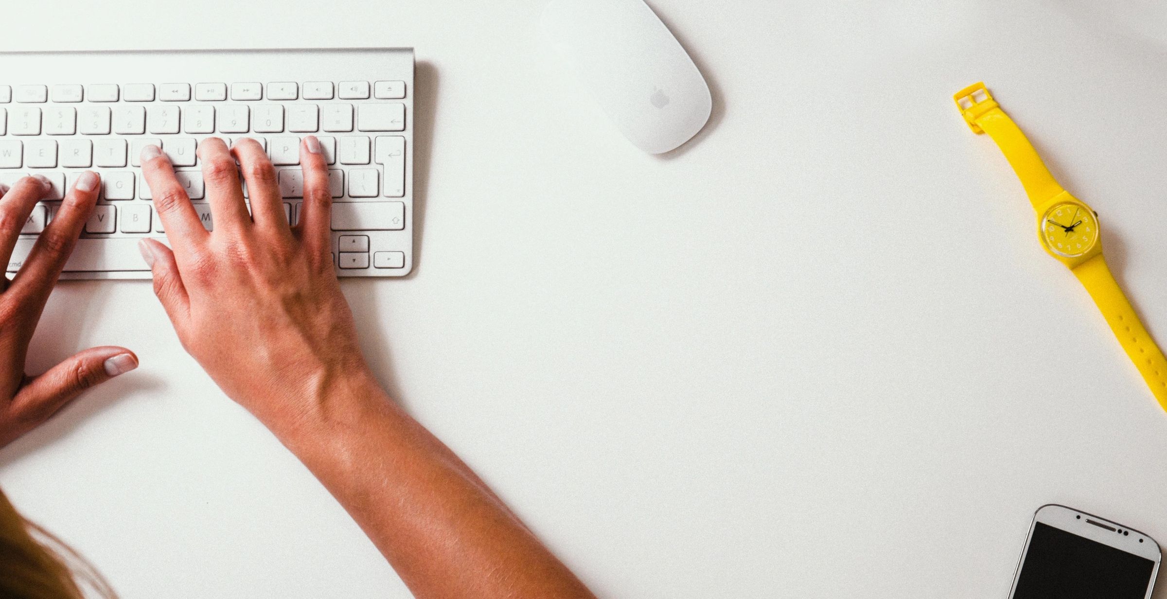 Hands typing on a computer